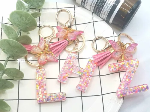Vista 4 de Meefisher Llavero de letra inicial de mariposa con borla rosa púrpura y estrella, para cartera, monederos, mochila, bolsos, alfabeto, llavero