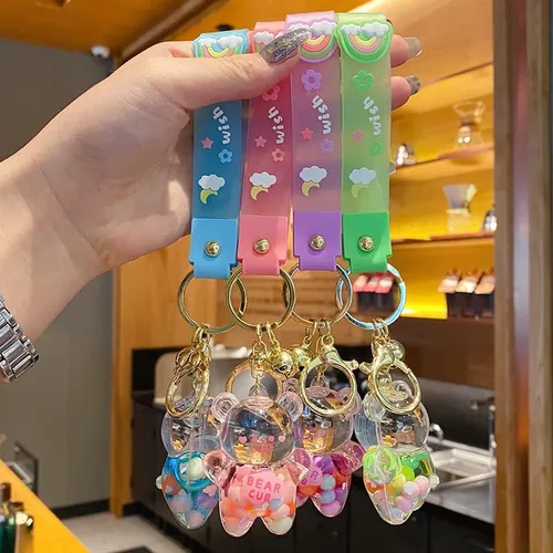 Vista 2 de BEXOA Lindo llavero líquido para regalo de Navidad, llavero Kawaii de Año Nuevo, colgante de mochila de oso flotante para mujeres y hombres