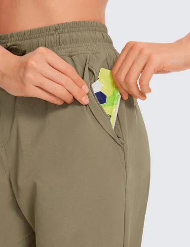 Vista 4 de CRZ YOGA Pantalones deportivos para mujer, impermeables, para exteriores, golf, atléticos, ligeros, con bolsillos con cremallera, de 27 pulgadas