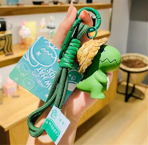 Vista 3 de Ergugos Llavero creativo de dibujos animados con diseño de dinosaurio, bolsa de estudiante, colgante para parejas, mujeres, llavero de coche, Verde