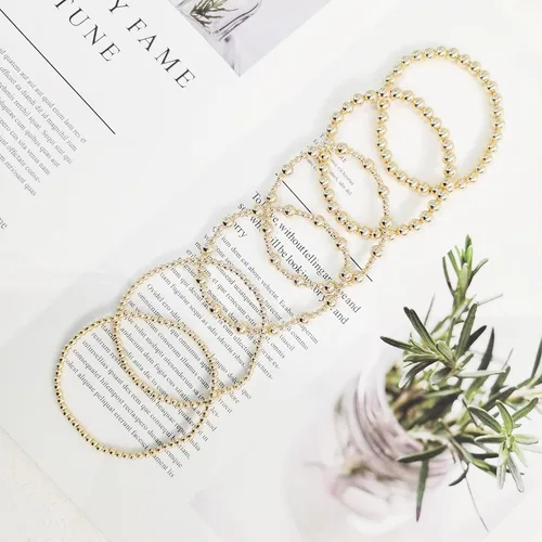 Vista 6 de Pulseras de oro para mujer, chapado en oro de 14 quilates, apilables, juego de pulseras elásticas de cuentas de oro, joyería de oro para mujer