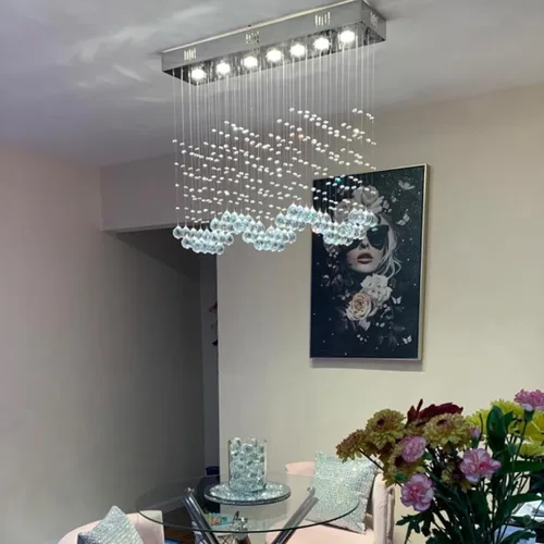 Vista 2 de Candelabro de cristal moderno de 7 luces rectangular de lujo con ondas, lámpara de techo empotrada colgante con gotas de lluvia cromada para isla