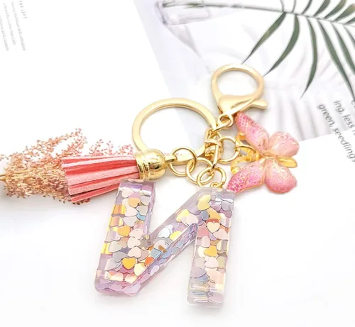 Vista 3 de OKAICEN Llavero con letra inicial del alfabeto, borla y mariposa, colgante para bolsos, mujeres y niñas