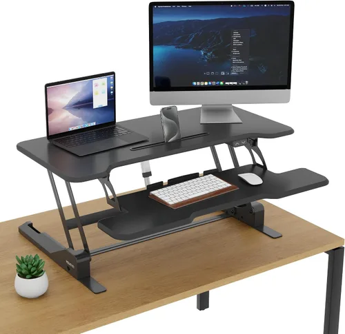 Vista 2 de Mount-It! Convertidor de escritorio eléctrico de pie con mesa de 38 pulgadas, elevador de escritorio de pie ajustable en altura, elevador